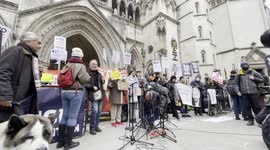 Julian Assange supporters gather outside the Royal Courts of Justice before trial results are announced
