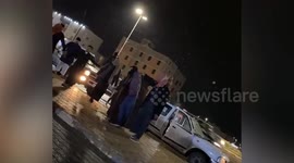Festive locals dance as light snow falls in northern Saudi Arabia