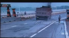 Truck smashes through China bridge's height barrier