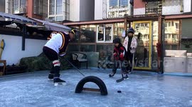Grandfather turns balcony into ICE RINK in northern China