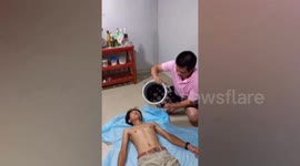 Man pours bucket of rhinoceros beetles over friend's body