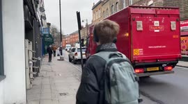 Traffic stalemate as car parks on side of narrow road in London