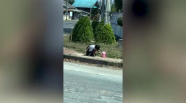Schoolgirl struggles with heavy backpack carrying gift for her mother before passer-by helps her