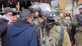 Israeli soldiers close shops in the Old City of the West Bank city of Hebron.