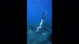 Beautiful woman finds peaceful moments while diving in the ocean