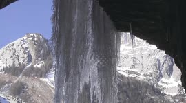 Photographer gets close-up footage of spectacular frozen waterfall in Switzerland