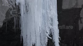 4K Close-up detailed close-up view on frozen waterfall ice stalactite in Switzerland