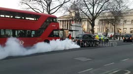 Smoke signals: London black taxi skirts through town blowing smoke like a chimney