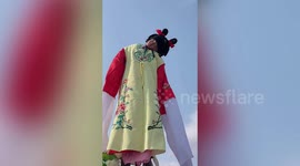 Toddler falls asleep during Chinese festival performance despite being hoisted in the air