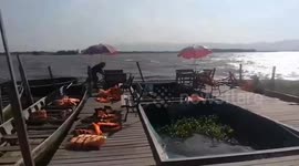 Strong wind and waves caused by dry season batter wooden docks in Thailand