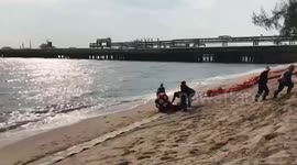 Locals clean beach after oil leak in eastern Thailand