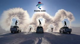 Chinese men throw boiling water above them to form Olympic rings in the air