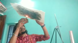 Artists creates portrait of Queen of Melody using fire & smoke on a piece of paper in Eastern India.