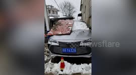Wall knocked down after car gets stuck in narrow alley in China