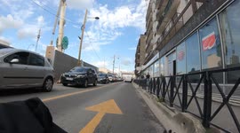 A cyclist almost hits the opening door of a parked van
