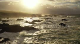 Drone footage captures stunning sunset at stormy Northern Ireland coastline