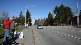 People on the side of the highway support 'Freedom Convoy' in Surrey, BC, Canada