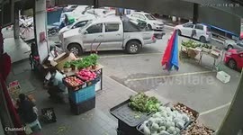 Woman scuffles with street vendors who set up shop in parking space in Malaysia