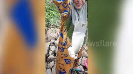 This Malaysian woman has unusual yet effective fishing technique using cut open plastic bottle