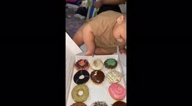 Indonesian boy falls into a pile of donuts but comes out with his pick stuck to his hands