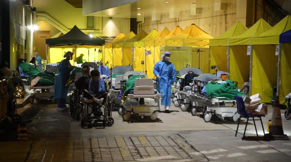 Patients forced to stay outside overnight as Hong Kong hospital buckles under COVID-19 spike
