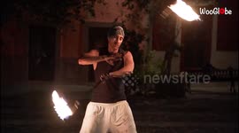 FEARLESS fire performer showcases SMOOTH tricks while spinning a meteor dart