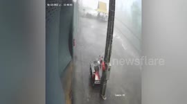 Wind and rain blows down metal door during storm in Thailand