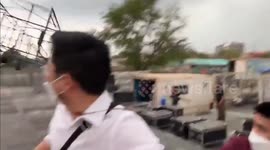 Dramatic moment man dodges falling STAGE blown over during storm