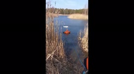 Firefighter crawls along frozen lake to rescue puppies abandoned in a bag