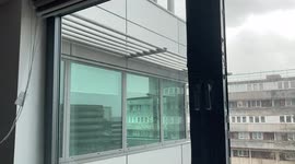 Storm Eunice - View from inside office where window has been blown out, causing massive rush of air through gap.