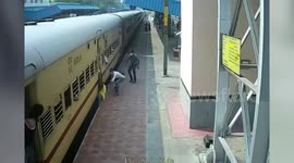 Man dangling from compartment of moving train holds on to dear life in southern India, saved by alert cop