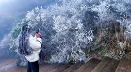Tourists' hair coated in layer of ice as freezing conditions take hold in southern China