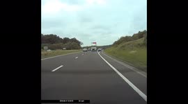 Car merging on a slip road and pushed along by HGV.