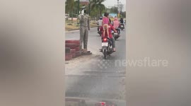 Reckless mother fined after riding motorcycle with three-year-old daughter STANDING on the back