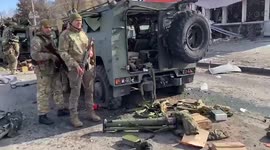 Ukrainian troops examine destroyed Russian convoy in Kharkiv on Day 4 of war