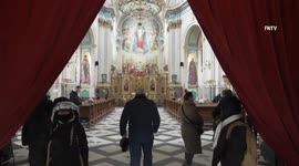 Refugees fleeing through western Ukraine shelter in cathedral catacombs