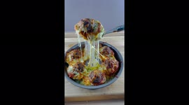 Chef makes amazing looking Garlic Bread Topped with meatballs and mozzarella cheese