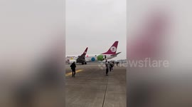 Passengers evacuated after plane's cargo hold fire alarm goes off during flight in China