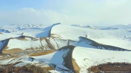 Stunning drone showcases snow-covered desert in China