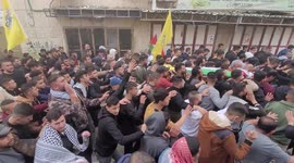 Mourners carry body of Palestinian Ammar Abu Afifa who was killed by Israeli forces during clashes during his funeral at the al-Arroub refugee camp in the West Bank city of Hebron