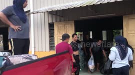 Residents deliver food to people affected by floods in Malaysia