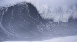 HUGE WAVE XXL wave at Nazare Portugal with surfer in february 2022