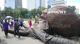 Protesters march through Indonesian capital with giant octopus sculpture on International Women's Day