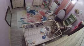 Naughty toddler climbs out of his crib while his mum is distracted