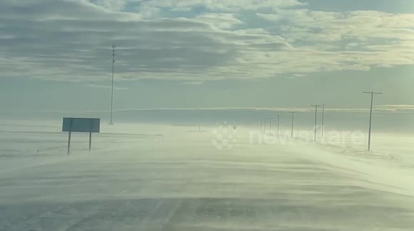 Blowing snow on icy roads cause dangerous driving conditions in Saskatchewan, Canada