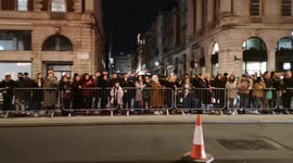 Fans stand in the middle of London road to spot celebrities arriving for BAFTA rehearsals