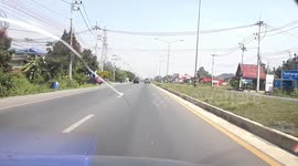 Step ladder falls from the back of moving pick-up truck in Thailand