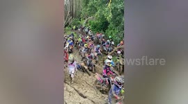 Dozens of off-road motorbike riders get stuck in thick mud during race in Indonesia