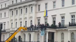 Police use a cherry picker to try and remove protesters from Russian oligarch’s London mansion