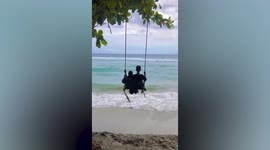 Hilarious moment woman is flung from beach swing in Indonesia